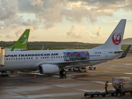 Japan Transocean Air and Spring Japan aircraft parked at New Ishigaki Airport in Okinawa, Japan, at dusk